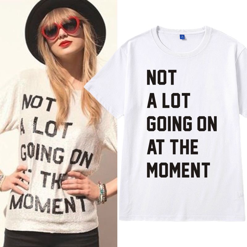 White Taylor Swift 22MV concert unisex T-shirt, 100% cotton, featuring "NOT A LOT GOING ON AT THE MOMENT" and other iconic text designs.