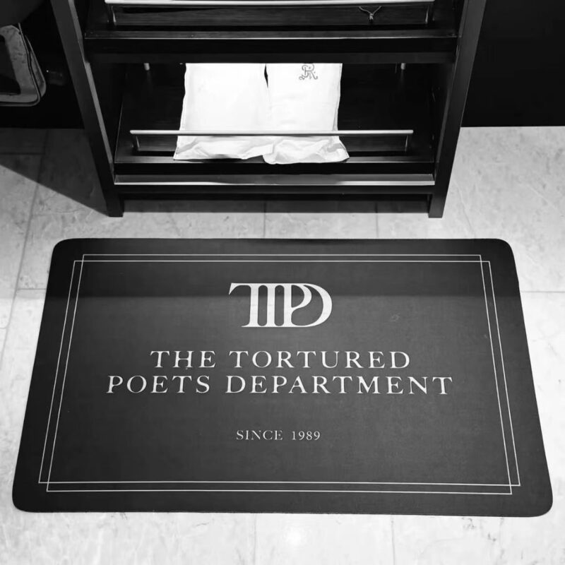Taylor Swift Tortured Poets Mat in Black and Smoked Grey designs, non-slip and absorbent, suitable for entryways and bathrooms, available in 5 sizes, inspired by 1989 era.